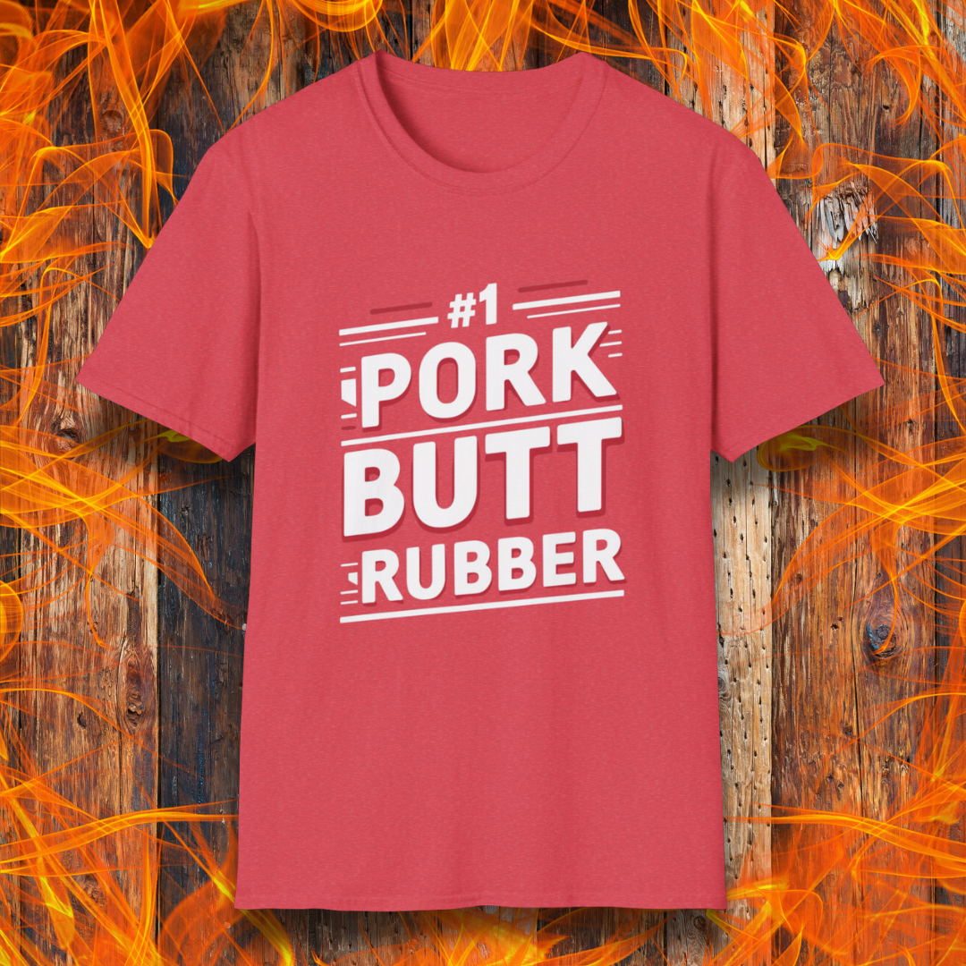Heather Red T-shirt featuring a bold, humorous BBQ-themed design that reads '#1 PORK BUTT RUBBER' in red and white block lettering with stylish line accents. A fun shirt for grill masters and barbecue enthusiasts.