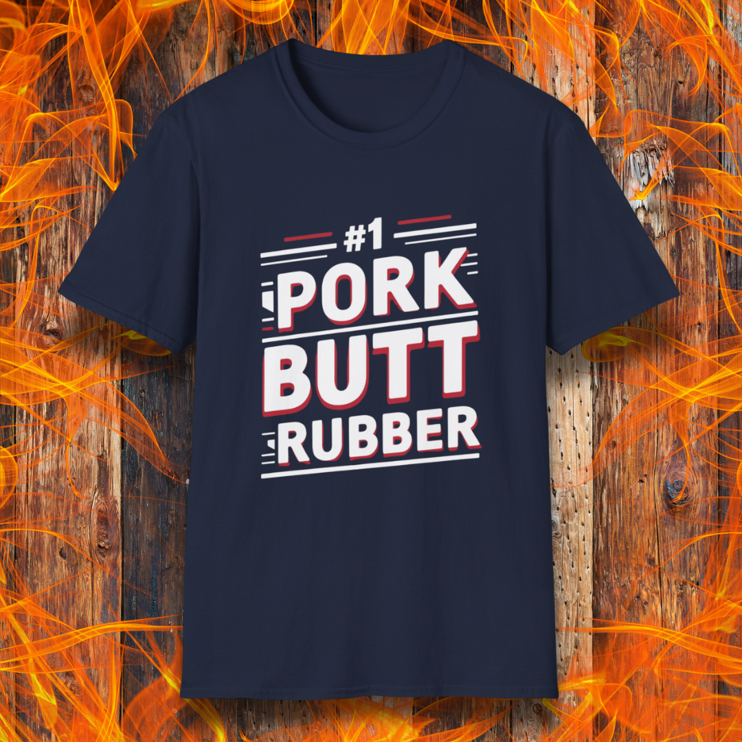 Navy T-shirt featuring a bold, humorous BBQ-themed design that reads '#1 PORK BUTT RUBBER' in red and white block lettering with stylish line accents. A fun shirt for grill masters and barbecue enthusiasts.
