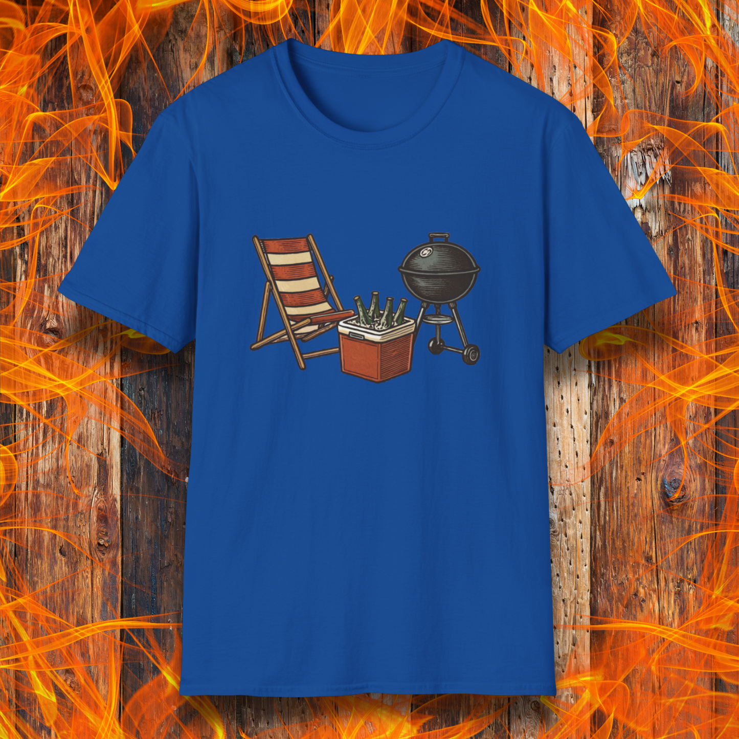 Blue t-shirt with a graphic of a grill, cooler, and chair on a wooden background with flames.