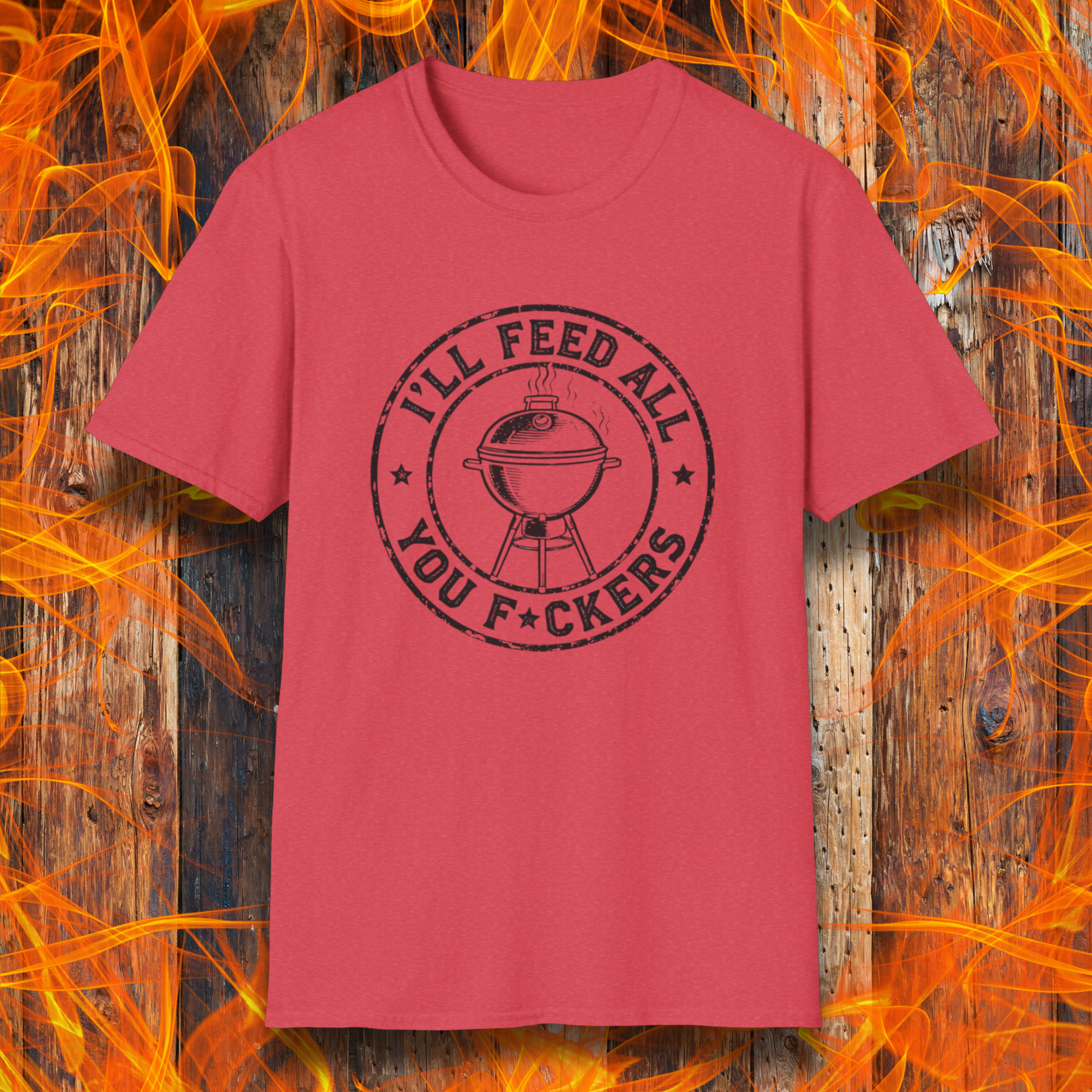 Red t-shirt with black graphic and text on a wooden background with flames.