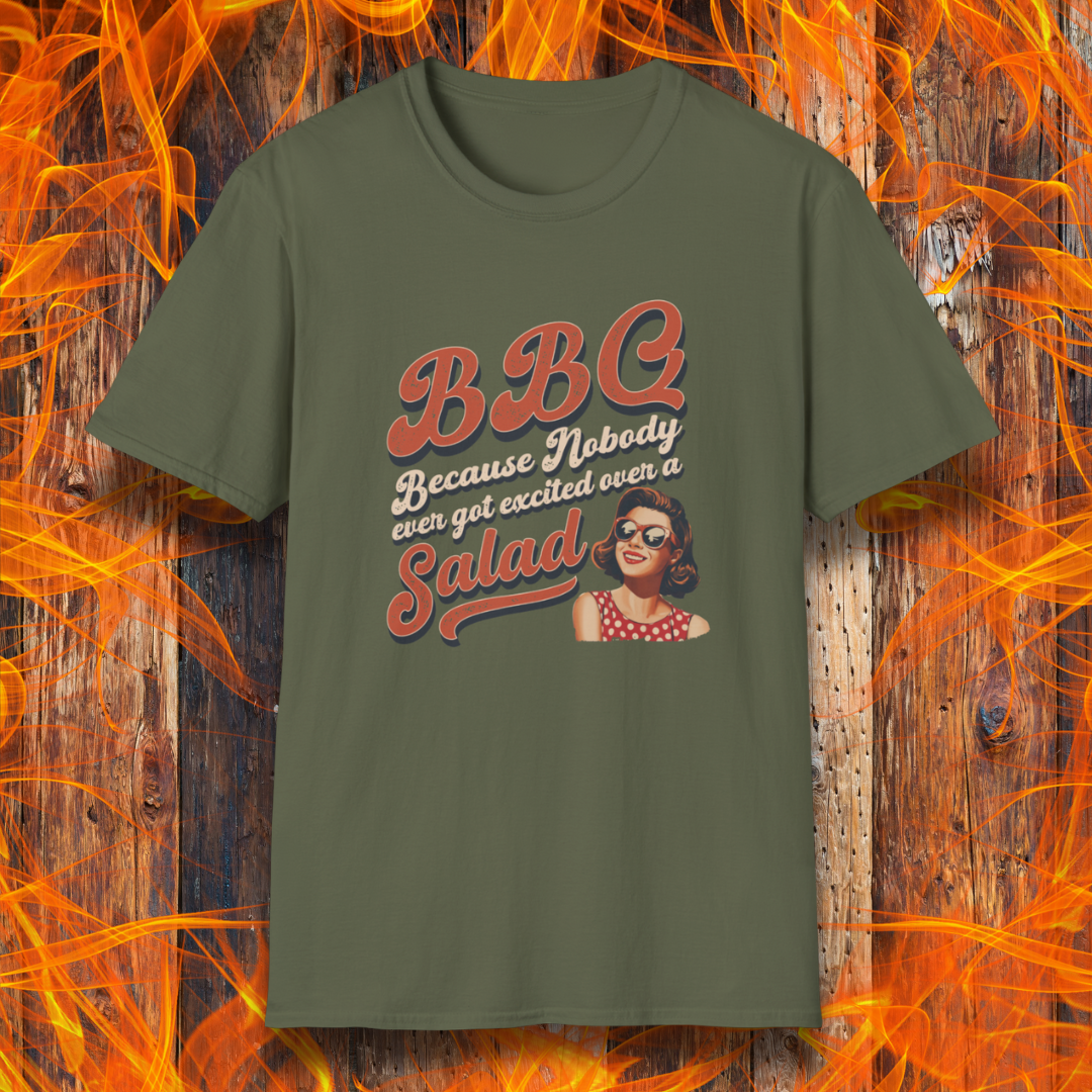 Green t-shirt with a graphic design on a wooden background with flames