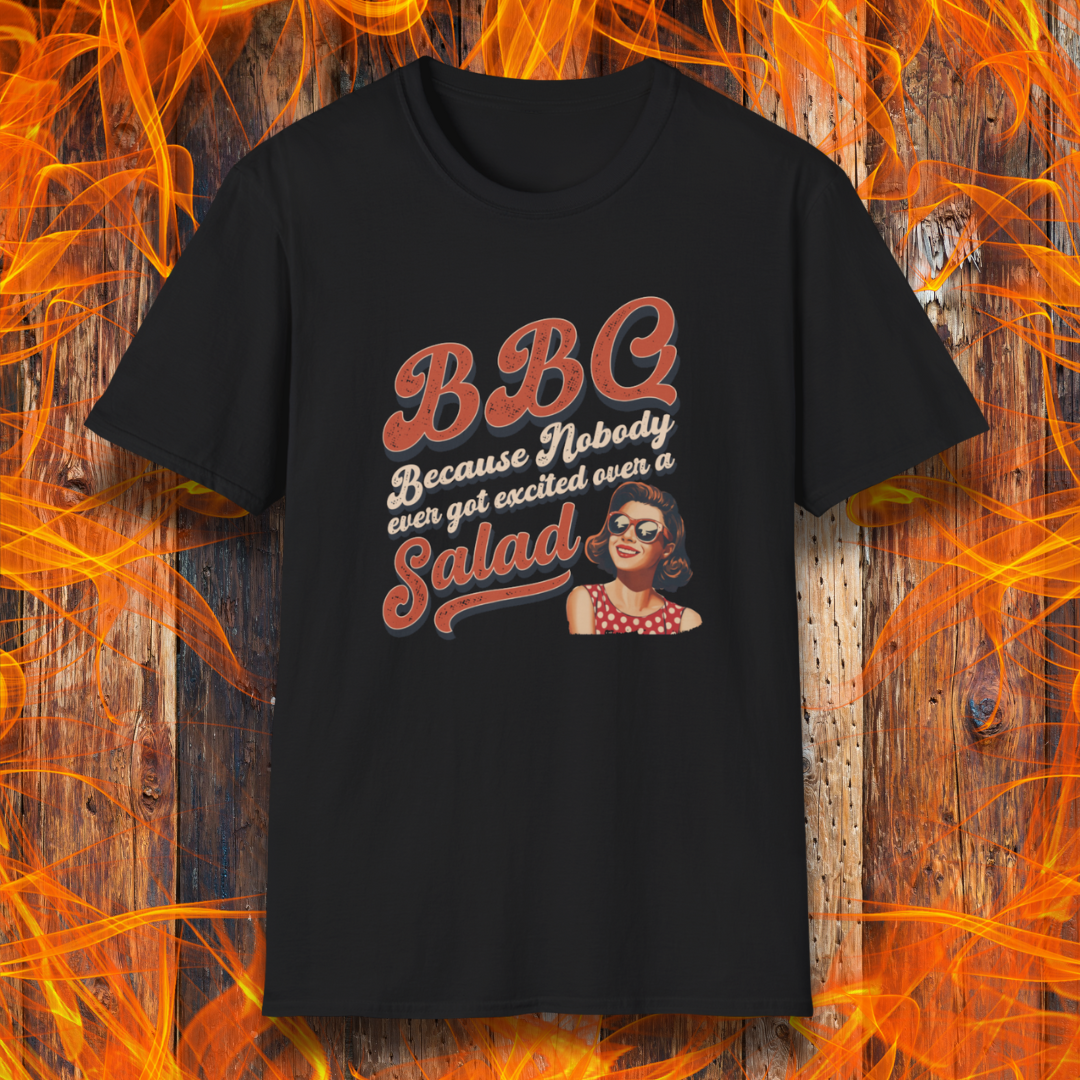 Black t-shirt with a graphic and text on a wooden background with flames