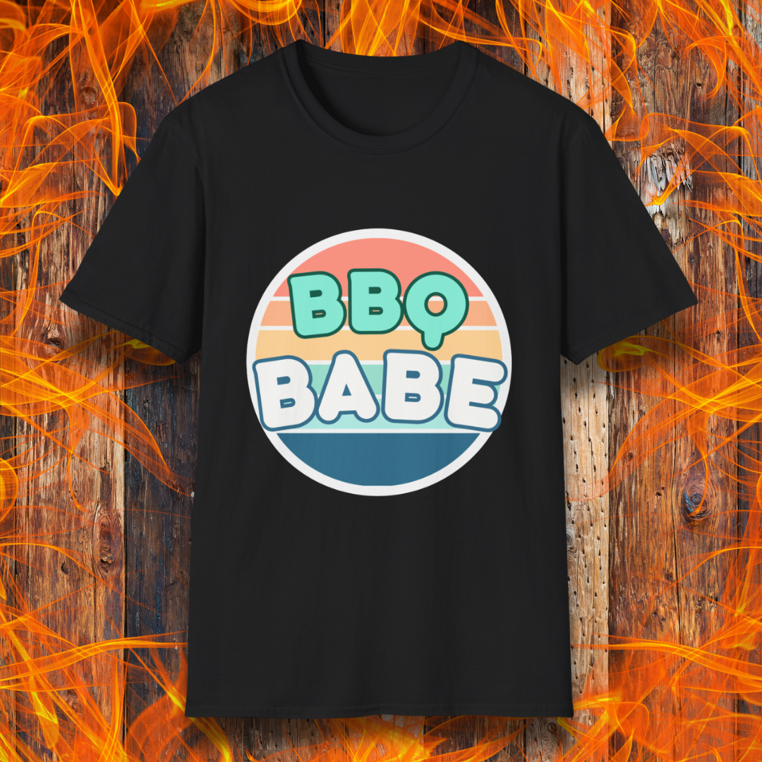 Black T-shirt with a retro-style 'BBQ Babe' design featuring bold, pastel lettering inside a vintage sunset circle. A fun and stylish choice for BBQ enthusiasts who love to grill in style.