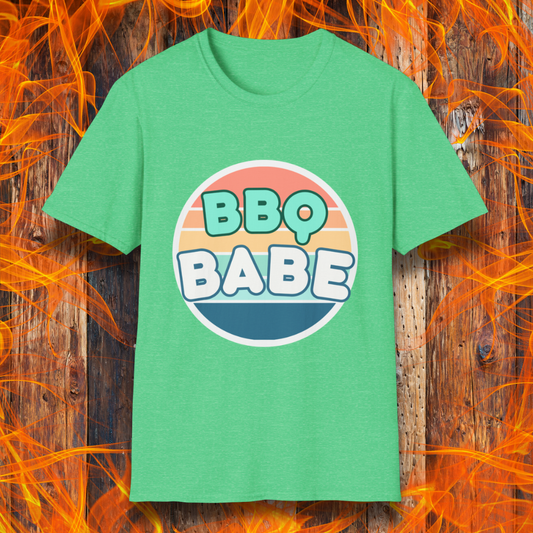 Heather Irish Green T-shirt with a retro-style 'BBQ Babe' design featuring bold, pastel lettering inside a vintage sunset circle. A fun and stylish choice for BBQ enthusiasts who love to grill in style.