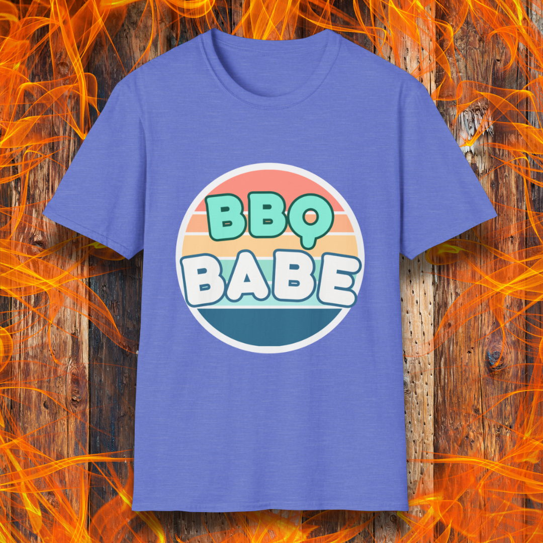 Heather Royal T-shirt with a retro-style 'BBQ Babe' design featuring bold, pastel lettering inside a vintage sunset circle. A fun and stylish choice for BBQ enthusiasts who love to grill in style.