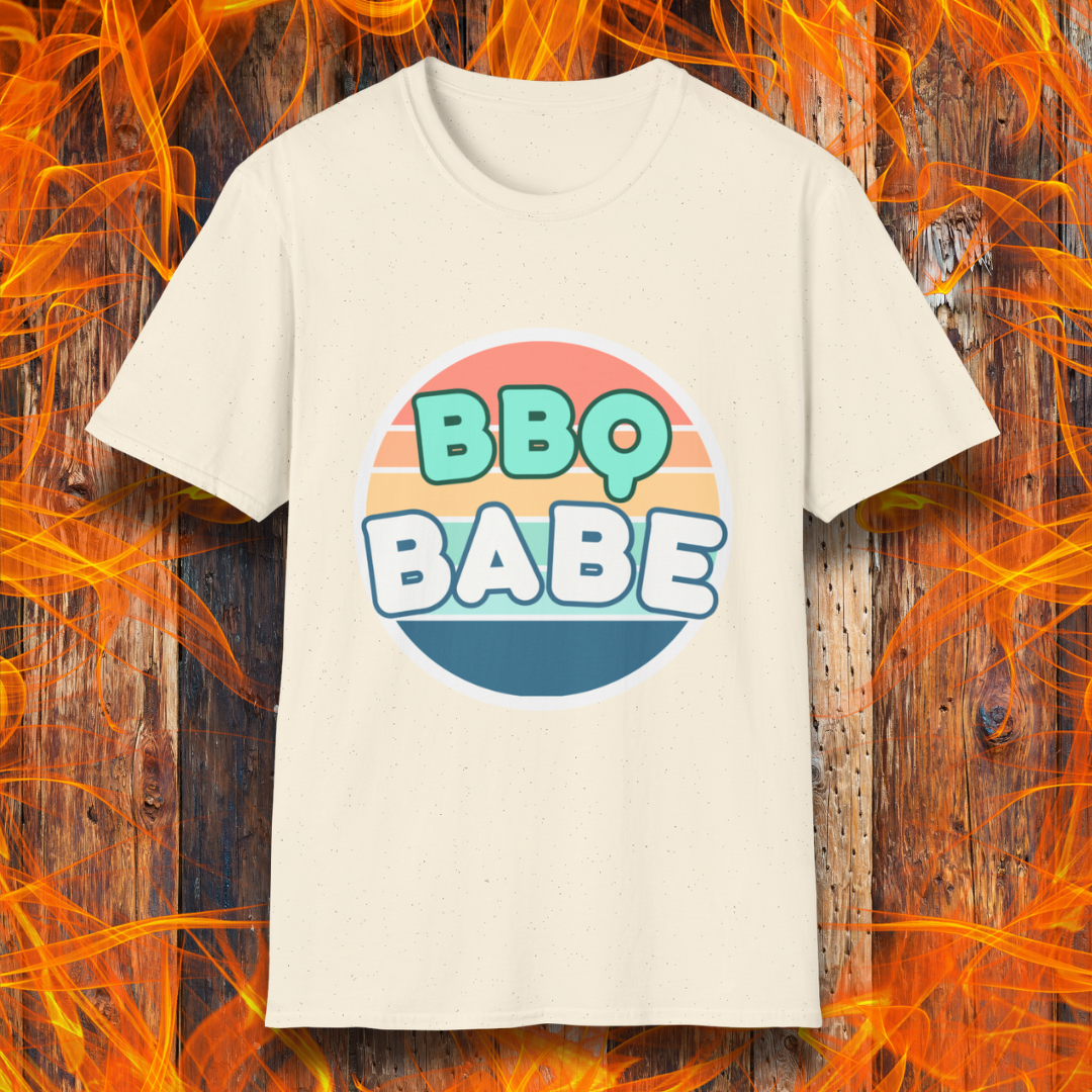 Natural Colored T-shirt with a retro-style 'BBQ Babe' design featuring bold, pastel lettering inside a vintage sunset circle. A fun and stylish choice for BBQ enthusiasts who love to grill in style.