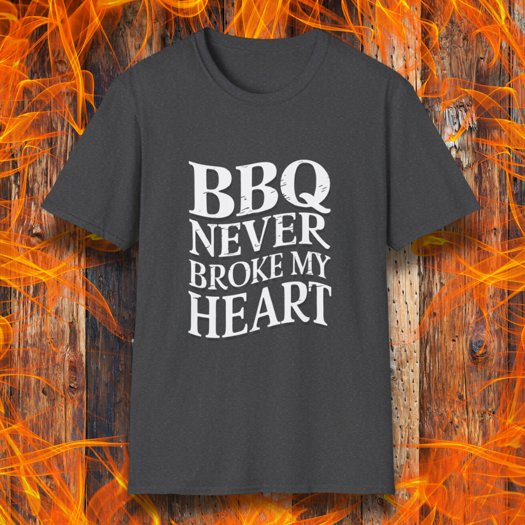 Dark Heather  t-shirt featuring bold white text that reads 'BBQ Never Broke My Heart' in a rustic, slightly distressed font, perfect for barbecue lovers who stay loyal to great smoked meats.