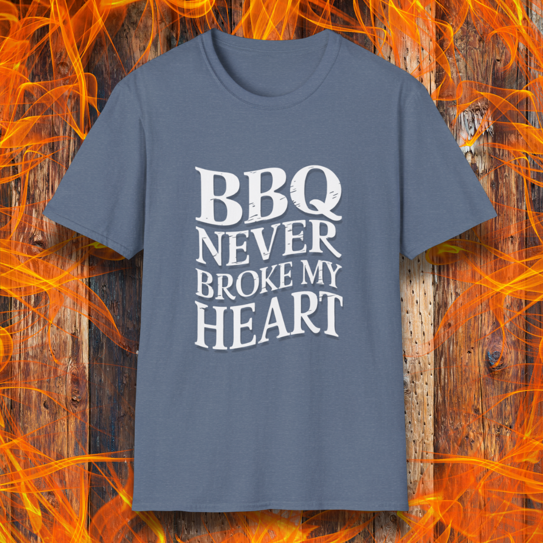 Heather Indigo t-shirt featuring bold white text that reads 'BBQ Never Broke My Heart' in a rustic, slightly distressed font, perfect for barbecue lovers who stay loyal to great smoked meats.