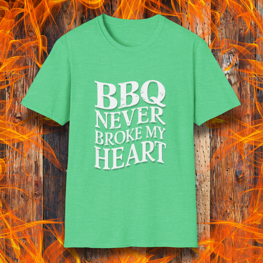 Heather Irish Green  t-shirt featuring bold white text that reads 'BBQ Never Broke My Heart' in a rustic, slightly distressed font, perfect for barbecue lovers who stay loyal to great smoked meats.