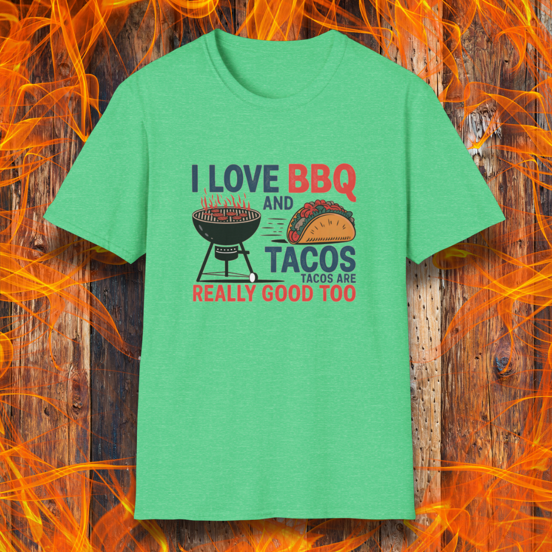 Heather Irish Green T-shirt features a fun and bold design that reads, "I Love BBQ and Tacos... Tacos Are Really Good Too," with graphics of a flaming grill and a delicious taco. Perfect for BBQ lovers who also enjoy a good taco, this shirt combines humor and food passion in a stylish way.
