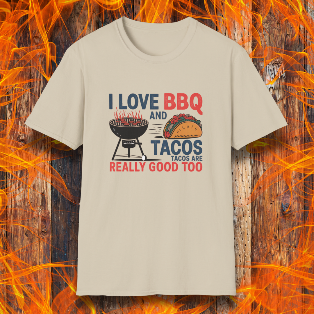 Sand T-shirt features a fun and bold design that reads, "I Love BBQ and Tacos... Tacos Are Really Good Too," with graphics of a flaming grill and a delicious taco. Perfect for BBQ lovers who also enjoy a good taco, this shirt combines humor and food passion in a stylish way.