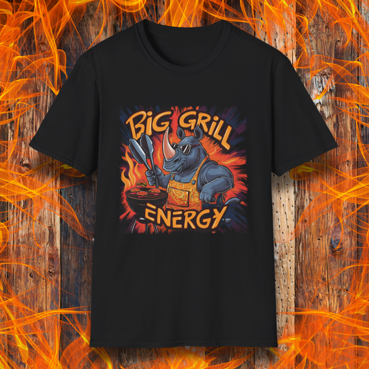 Black t-shirt featuring a bold and vibrant design of a muscular rhino wearing sunglasses and an apron, grilling meat with tongs in hand. The fiery background highlights the phrase 'Big Grill Energy' in dynamic, flame-inspired lettering