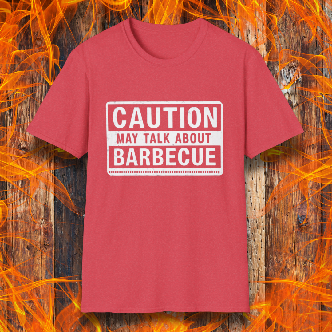 Heather Red T-shirt featuring a bold, high-contrast design resembling a caution sign. The text reads 'CAUTION MAY TALK ABOUT BARBECUE' in white, with a distressed effect, making it perfect for BBQ enthusiasts who love to chat about grilling.