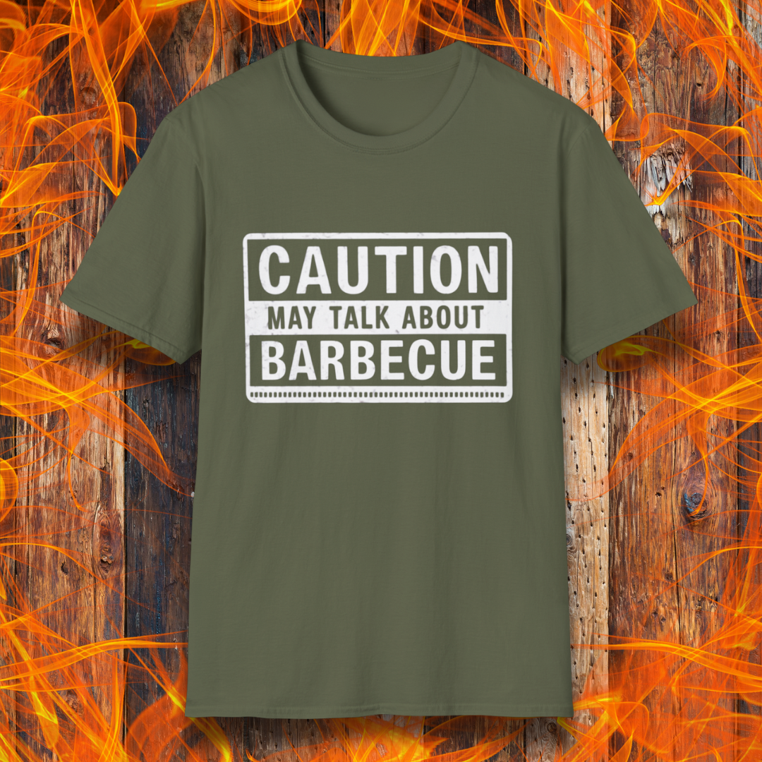 Military Green T-shirt featuring a bold, high-contrast design resembling a caution sign. The text reads 'CAUTION MAY TALK ABOUT BARBECUE' in white, with a distressed effect, making it perfect for BBQ enthusiasts who love to chat about grilling.