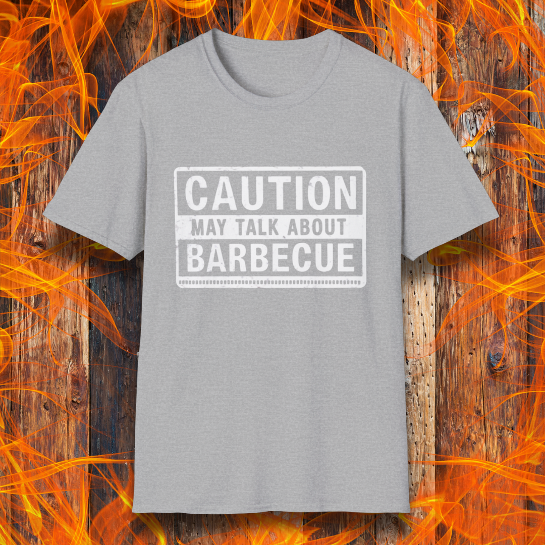 Sport Grey T-shirt featuring a bold, high-contrast design resembling a caution sign. The text reads 'CAUTION MAY TALK ABOUT BARBECUE' in white, with a distressed effect, making it perfect for BBQ enthusiasts who love to chat about grilling.