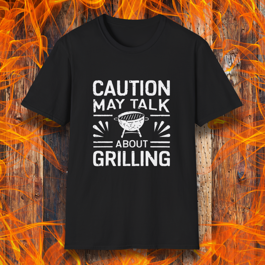 Black T-shirt featuring bold white text that reads 'CAUTION MAY TALK ABOUT GRILLING,' with a vintage-style BBQ grill illustration and decorative lines. Perfect for passionate grill masters who can't stop talking about barbecue.