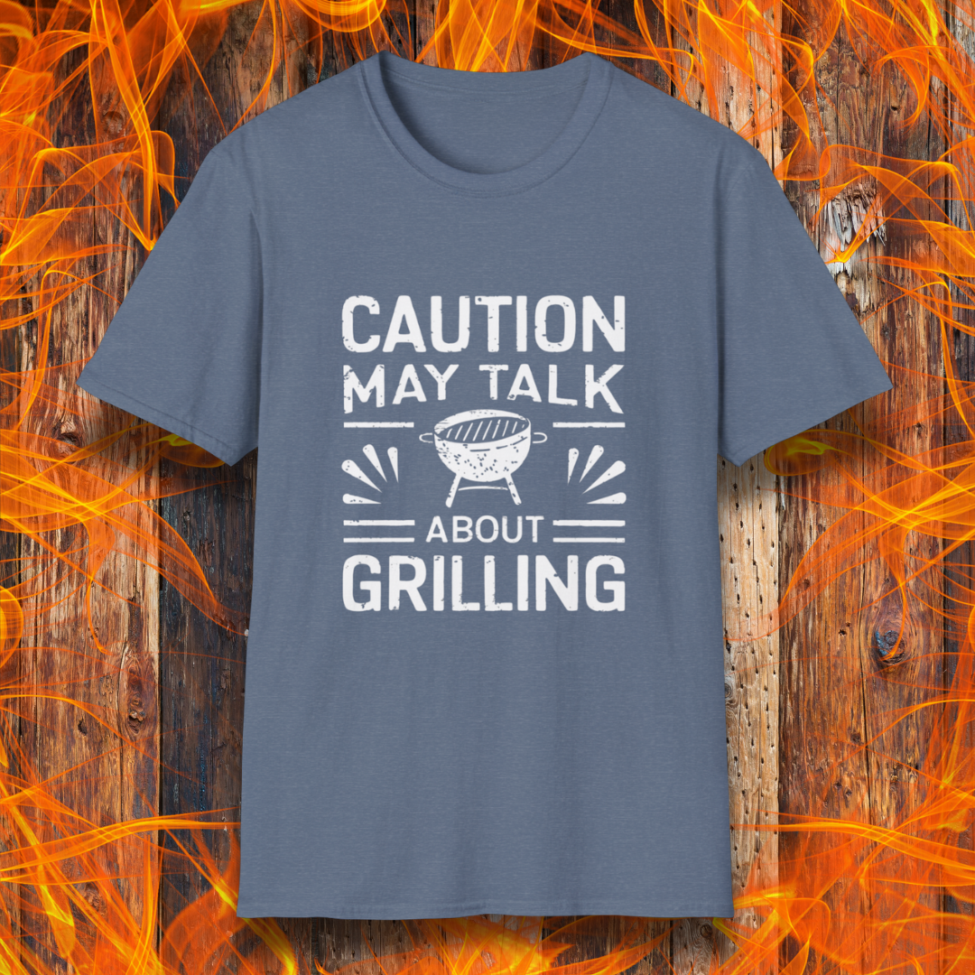 Heather Indigo T-shirt featuring bold white text that reads 'CAUTION MAY TALK ABOUT GRILLING,' with a vintage-style BBQ grill illustration and decorative lines. Perfect for passionate grill masters who can't stop talking about barbecue.