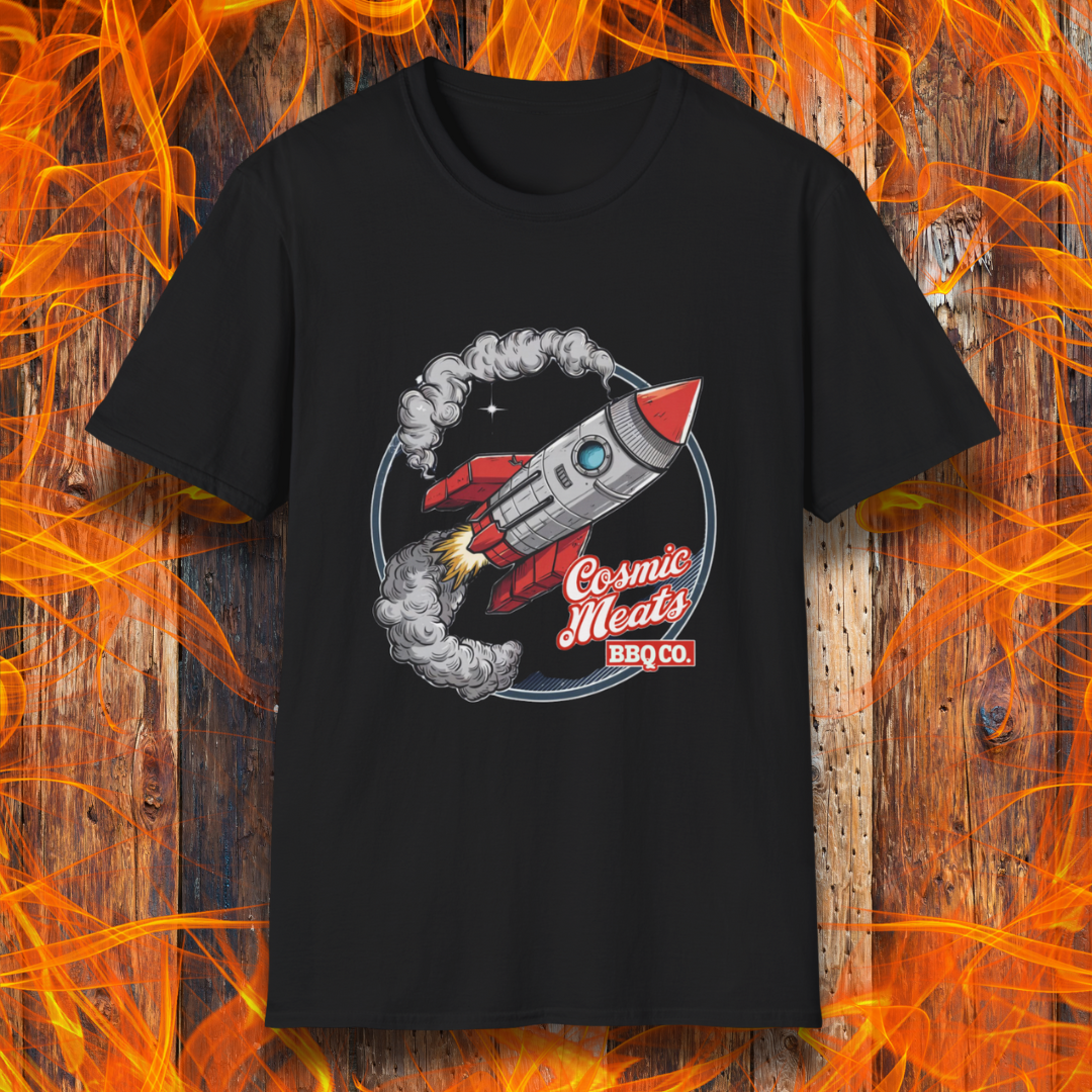 Black t-shirt featuring a retro-style rocket blasting off with smoke trails, paired with the text 'Cosmic Meats BBQ Co.'—a fun BBQ-themed space design.