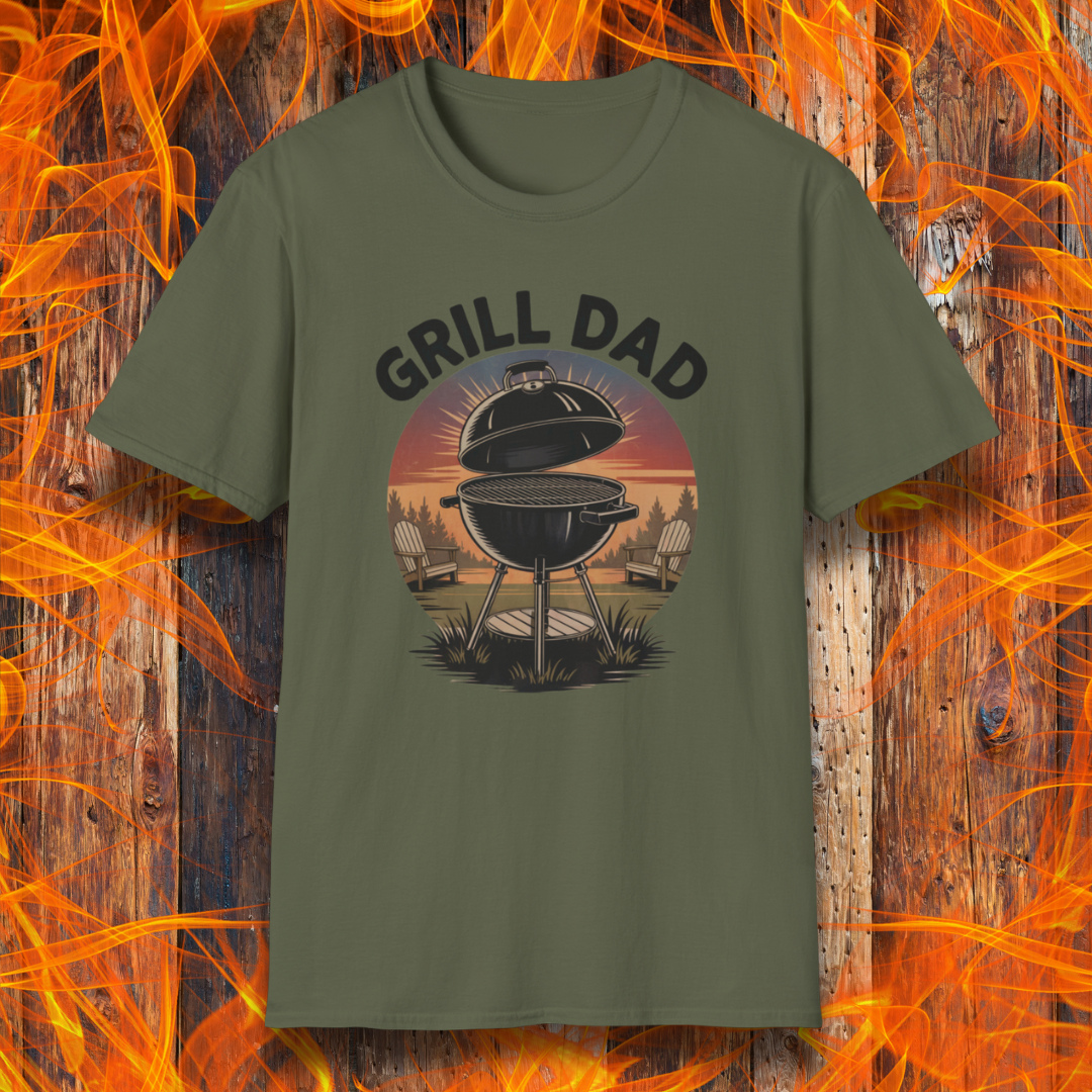 Military Green t-shirt with 'GRILL DAD' graphic on a wooden background with flames.