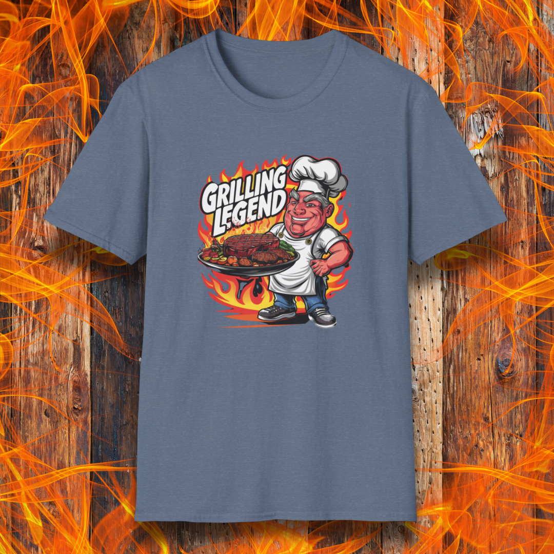 Heather Indigo t-shirt featuring a cartoon-style chef character holding a platter of perfectly grilled meats, with flames in the background and bold text that reads 'Grilling Legend'—ideal for BBQ masters and pit bosses