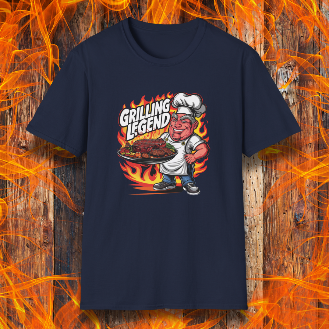 Navy t-shirt featuring a cartoon-style chef character holding a platter of perfectly grilled meats, with flames in the background and bold text that reads 'Grilling Legend'—ideal for BBQ masters and pit bosses