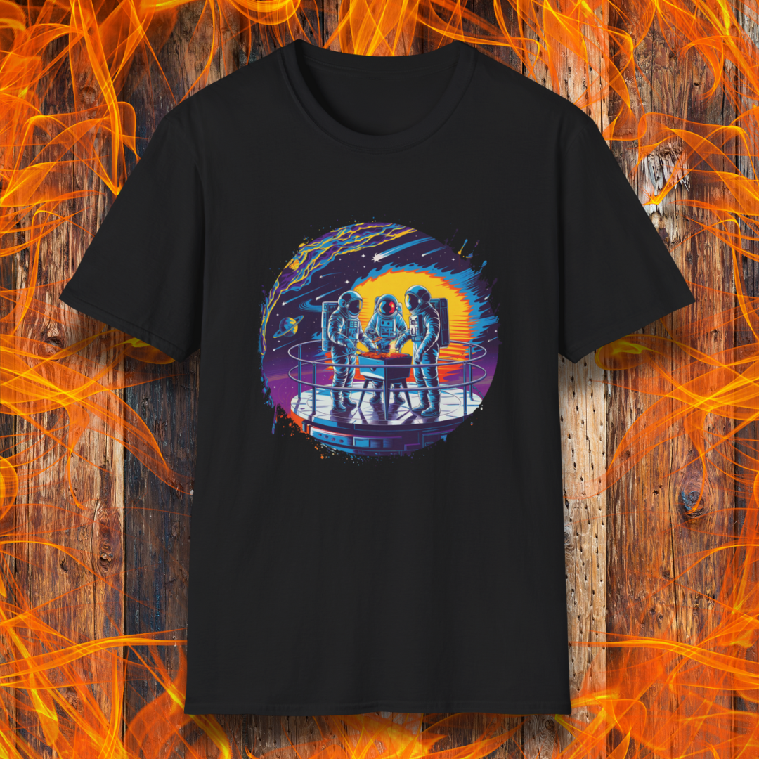 Black T-shirt showcases a vibrant, futuristic design featuring astronauts grilling in space. The scene is set on a metallic space station platform, with a cosmic backdrop of planets, stars, and a fiery explosion. The detailed artwork blends sci-fi with BBQ culture, making it a perfect choice for grilling enthusiasts who love a unique, out-of-this-world theme.