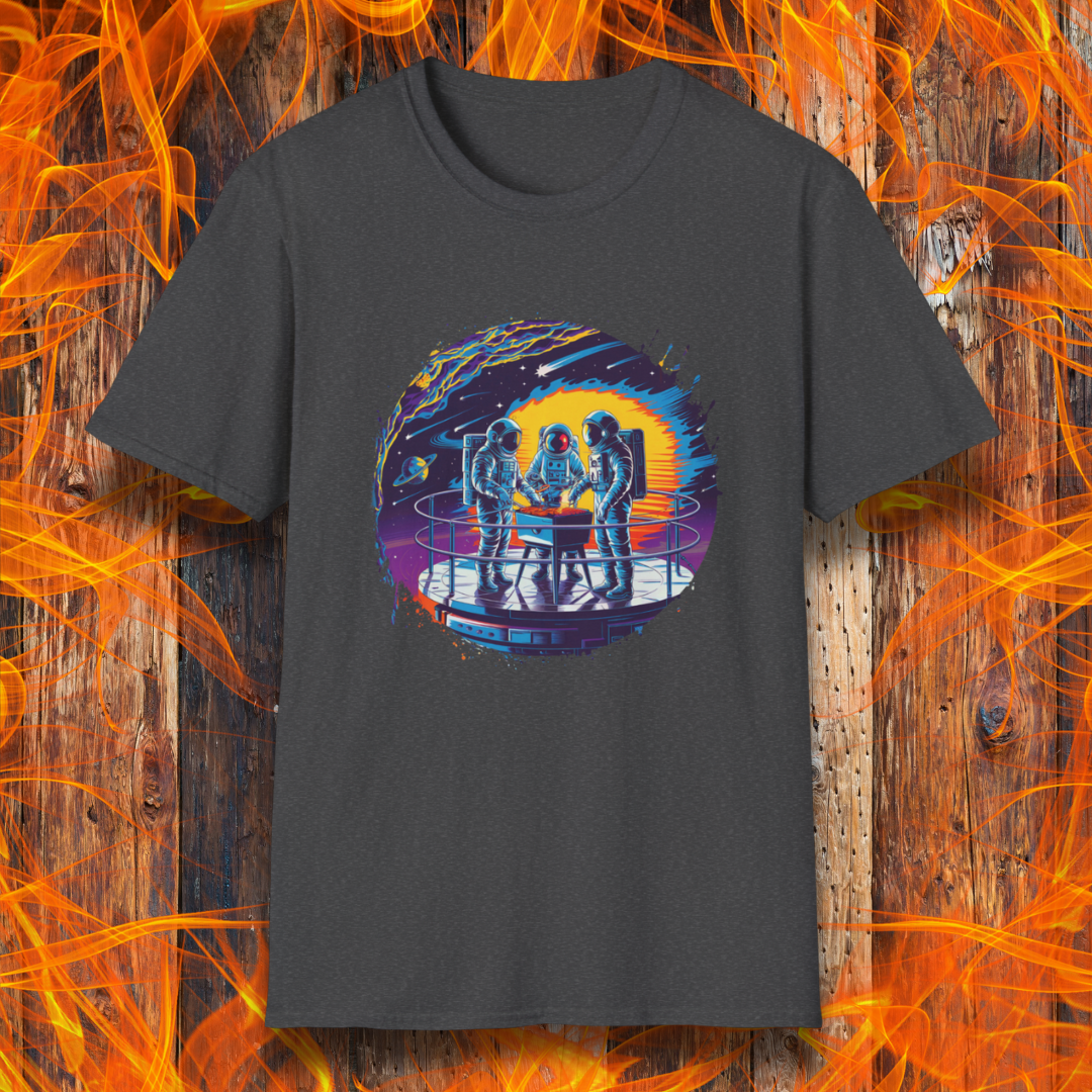 Dark Heather T-shirt showcases a vibrant, futuristic design featuring astronauts grilling in space. The scene is set on a metallic space station platform, with a cosmic backdrop of planets, stars, and a fiery explosion. The detailed artwork blends sci-fi with BBQ culture, making it a perfect choice for grilling enthusiasts who love a unique, out-of-this-world theme.