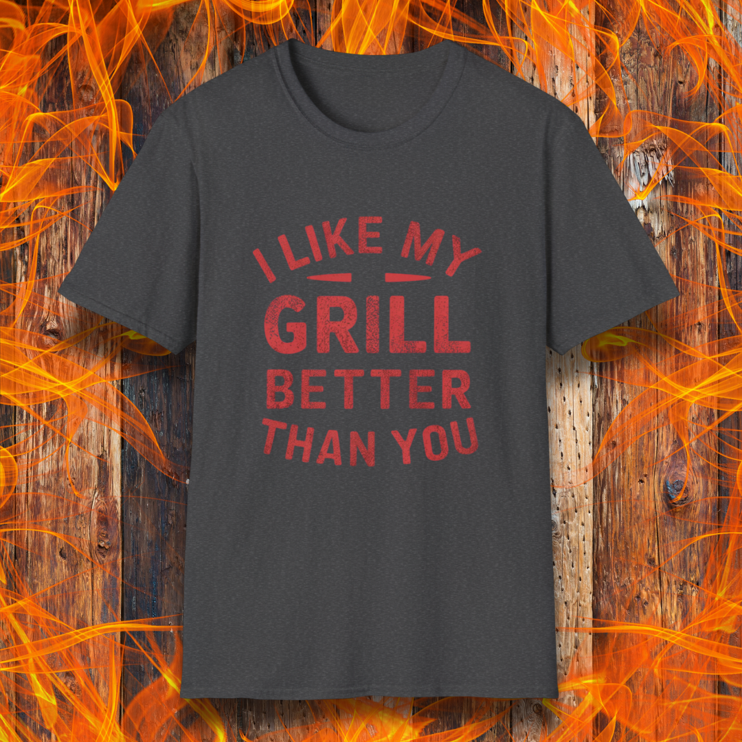 Dark Heather T-shirt with a bold and humorous BBQ-themed design. The red distressed-style text reads 'I Like My Grill Better Than You' in an arched layout, perfect for grill masters who take their barbecue seriously. A fun and stylish shirt for BBQ enthusiasts."