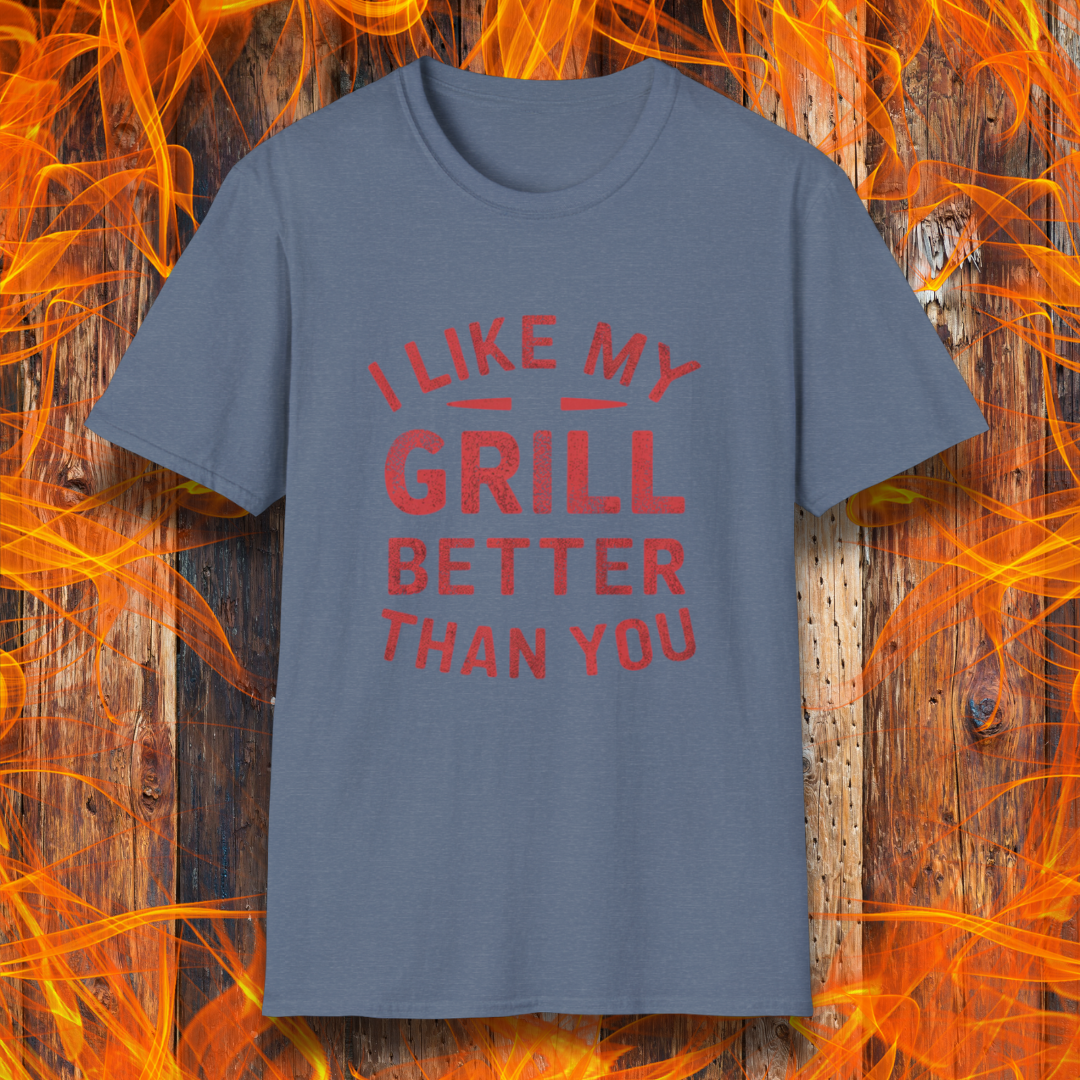 Heather Indigo T-shirt with a bold and humorous BBQ-themed design. The red distressed-style text reads 'I Like My Grill Better Than You' in an arched layout, perfect for grill masters who take their barbecue seriously. A fun and stylish shirt for BBQ enthusiasts."