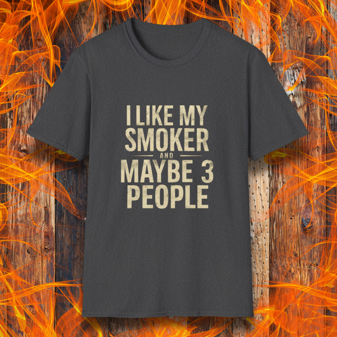 Dark Heather T-shirt featuring bold, distressed beige text that reads, 'I Like My Smoker And Maybe 3 People.' A humorous BBQ-themed shirt perfect for pitmasters and grilling enthusiasts who prefer the company of their smoker over most people!