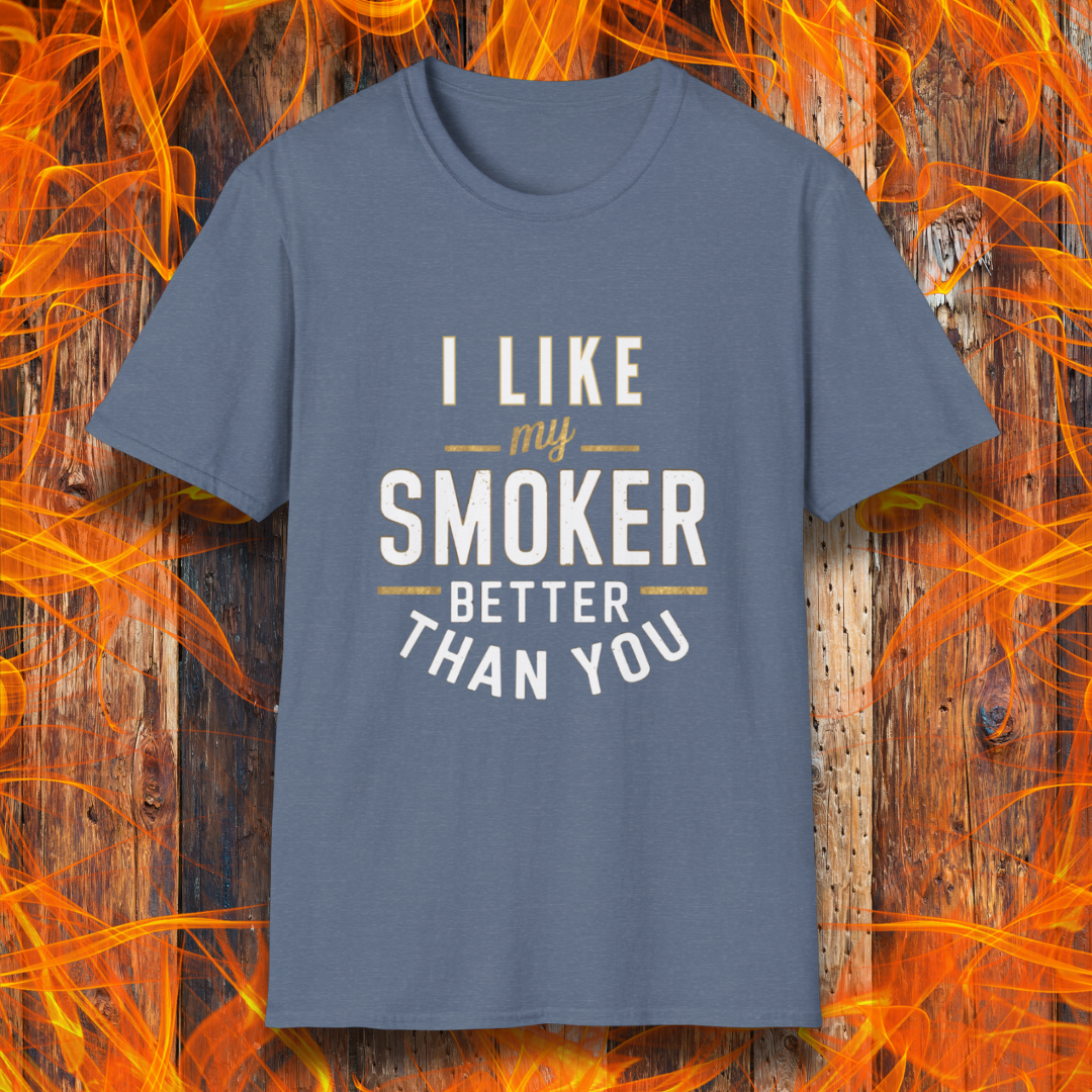 Heather Red T-shirt featuring a witty BBQ-themed design. The bold text reads 'I Like My Smoker Better Than You' in a mix of white and gold lettering, with decorative lines adding emphasis. A perfect shirt for grill masters and smoking enthusiasts with a sense of humor.