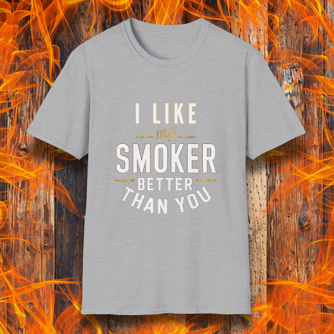 Sport Grey T-shirt featuring a witty BBQ-themed design. The bold text reads 'I Like My Smoker Better Than You' in a mix of white and gold lettering, with decorative lines adding emphasis. A perfect shirt for grill masters and smoking enthusiasts with a sense of humor.