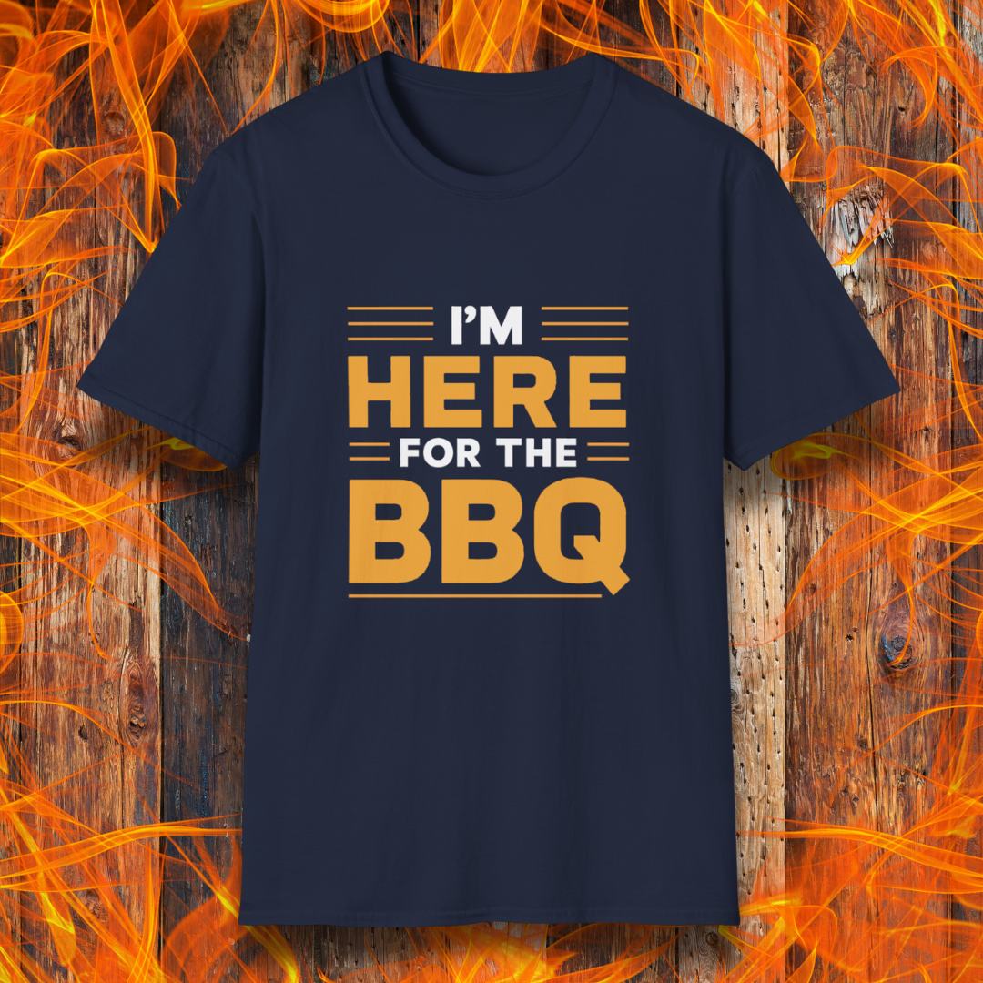 Navy T-shirt with bold text reading 'I'M HERE FOR THE BBQ' in orange and white, accented with horizontal lines for emphasis. A stylish and fun design for BBQ lovers and grill masters.
