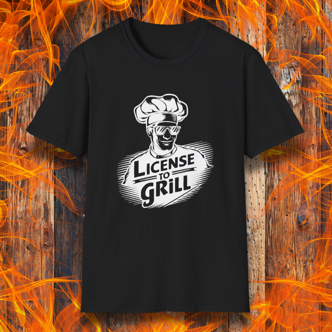 Black  t-shirt featuring a bold white graphic of a cool chef wearing sunglasses and a toque, with the phrase 'License to Grill' in a dynamic retro-style font.