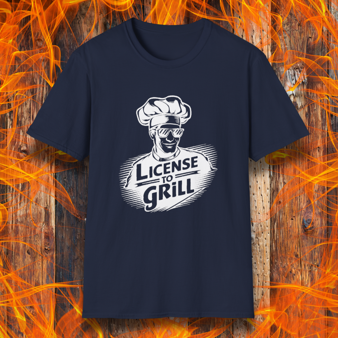 Navy t-shirt featuring a bold white graphic of a cool chef wearing sunglasses and a toque, with the phrase 'License to Grill' in a dynamic retro-style font.