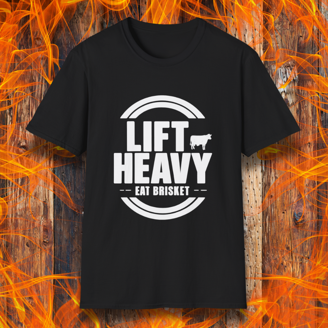 Black colored T-shirt with "LIFT HEAVY EAT BRISKET" in bold text and a cow silhouette. Perfect for BBQ lovers, gym-goers, and meat-smoking enthusiasts.