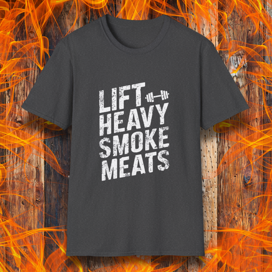 Dark Heather T-shirt with bold, distressed white text reading 'Lift Heavy Smoke Meats,' featuring a barbell icon. A perfect fit for BBQ lovers and gym enthusiasts who take their grilling and gains seriously!