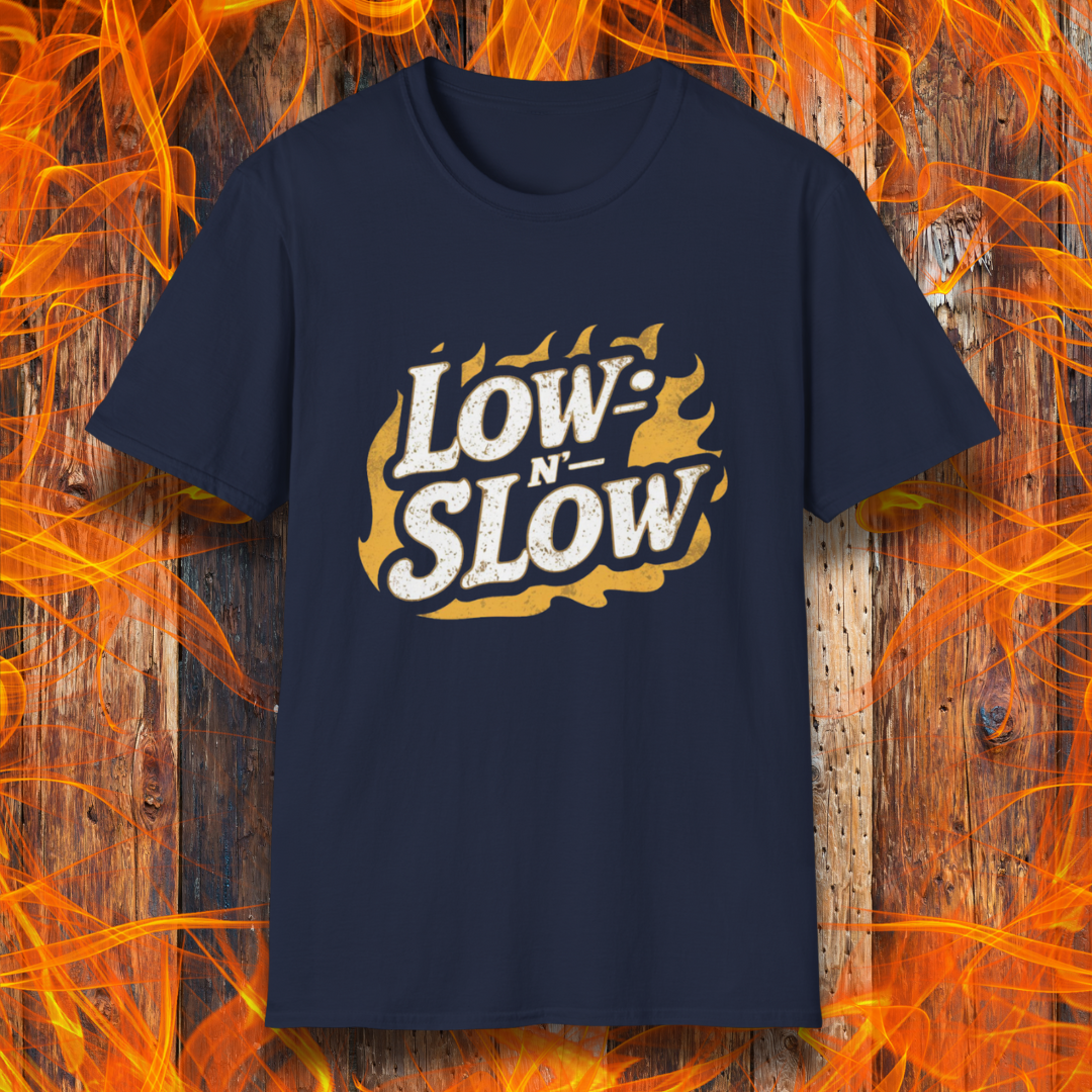 Navy T-shirt featuring 'Low-N-Slow' in bold, distressed lettering over a fiery background. Perfect for BBQ pitmasters who know that great barbecue takes time!