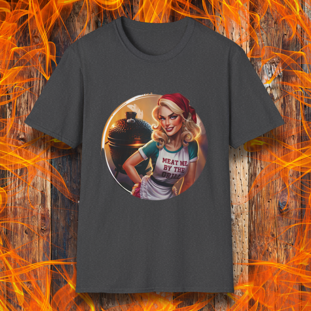 Dark Heather t-shirt featuring a vintage-inspired pin-up style woman in front of a charcoal grill, wearing an apron that reads 'Meat Me By The Grill.'"