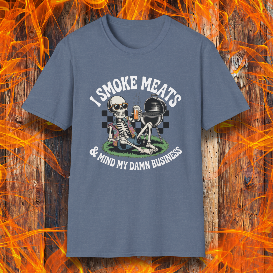 Heather Indigo t-shirt with a skeleton graphic and text 'I Smoke Meats & Mind My Damn Business' on a fiery background.
