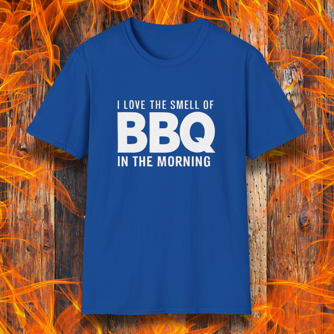 Royal Blue t-shirt with the phrase 'I Love the Smell of BBQ in the Morning' in bold white text, displayed against a fiery wooden background