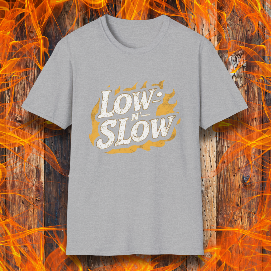 Sport Grey T-shirt featuring 'Low-N-Slow' in bold, distressed lettering over a fiery background. Perfect for BBQ pitmasters who know that great barbecue takes time!