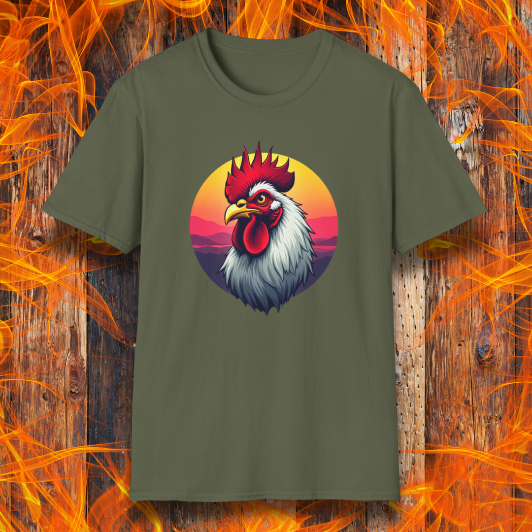 Military Green T-shirt featuring a bold and colorful illustration of a rooster with a dramatic red comb and white feathers, set against a circular sunset background with warm hues of orange, pink, and purple. The design exudes a rustic and vibrant aesthetic, perfect for BBQ and farm-style enthusiasts.