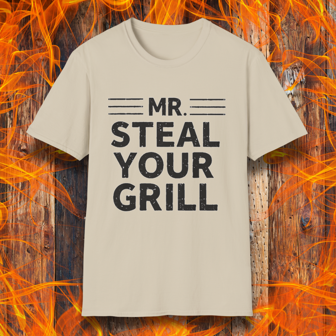 Sand T-shirt featuring bold, distressed black text that reads "MR. STEAL YOUR GRILL," with horizontal lines above and below "MR." The design is playful and humorous, perfect for BBQ enthusiasts who take pride in their grilling skills.