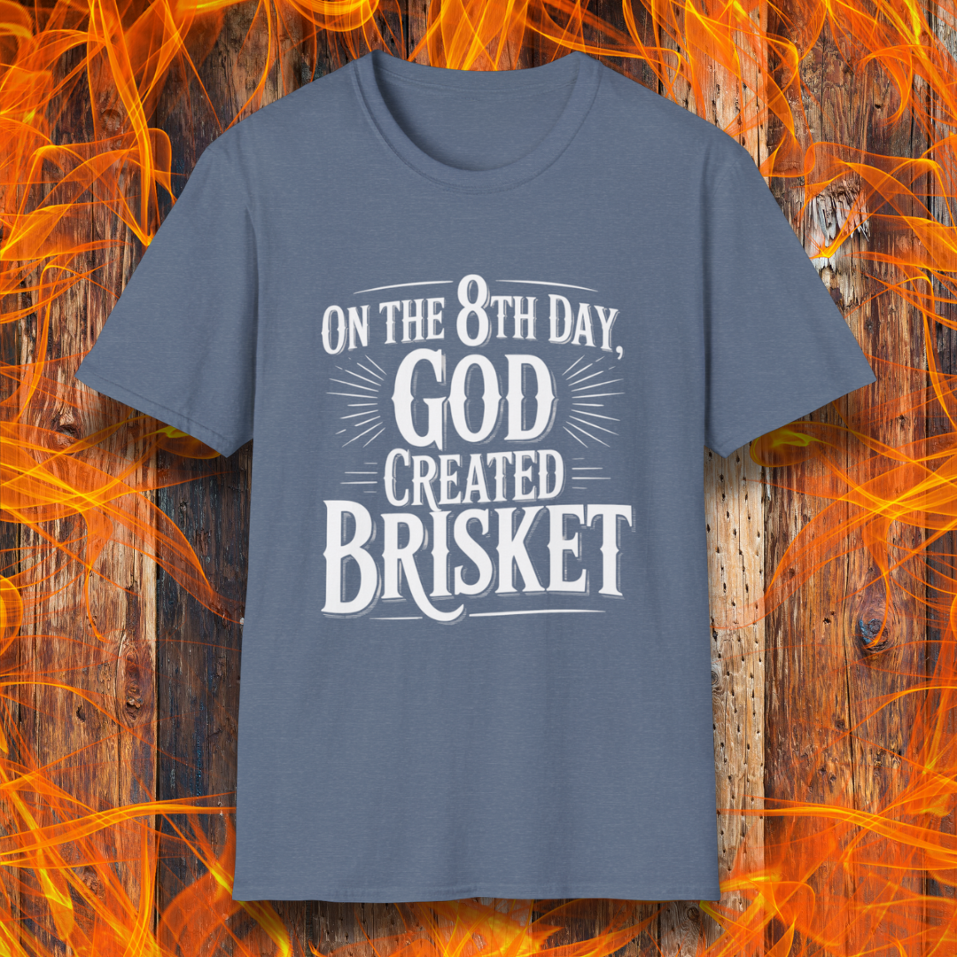 Heather Indigo t-shirt with bold white lettering that declares “On the 8th Day, God Created Brisket.” A divine pick for pitmasters who treat smoked meat like gospel.
