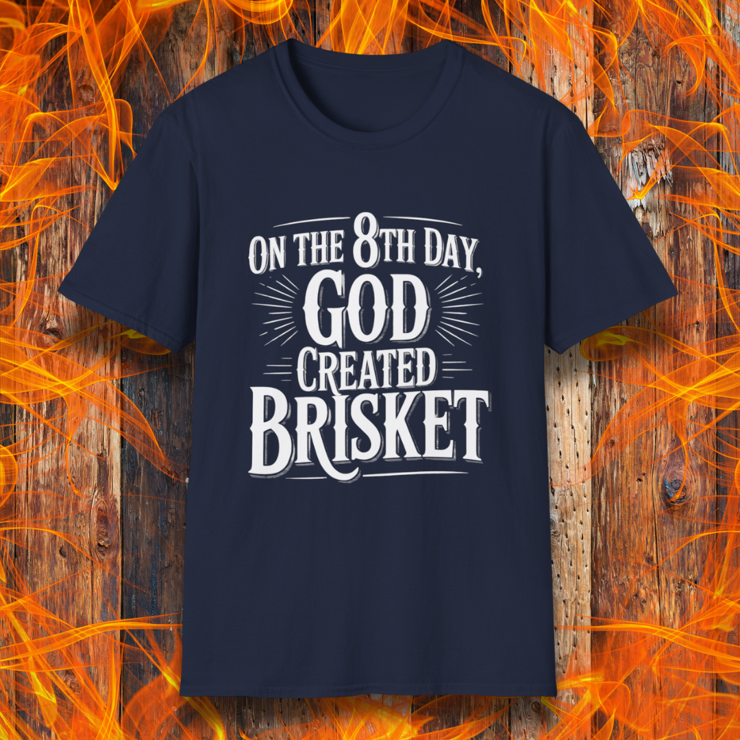 Navy t-shirt with bold white lettering that declares “On the 8th Day, God Created Brisket.” A divine pick for pitmasters who treat smoked meat like gospel.