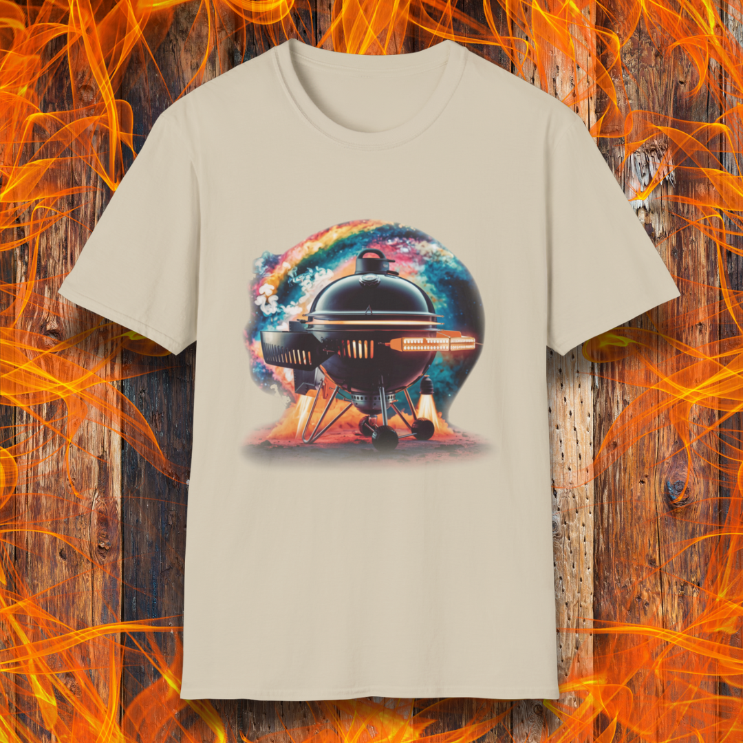 Sand T-shirt featuring a futuristic BBQ kettle grill designed like a rocket ship, with glowing thrusters, steam, and a cosmic background. A perfect design for BBQ lovers with a passion for sci-fi and grilling.