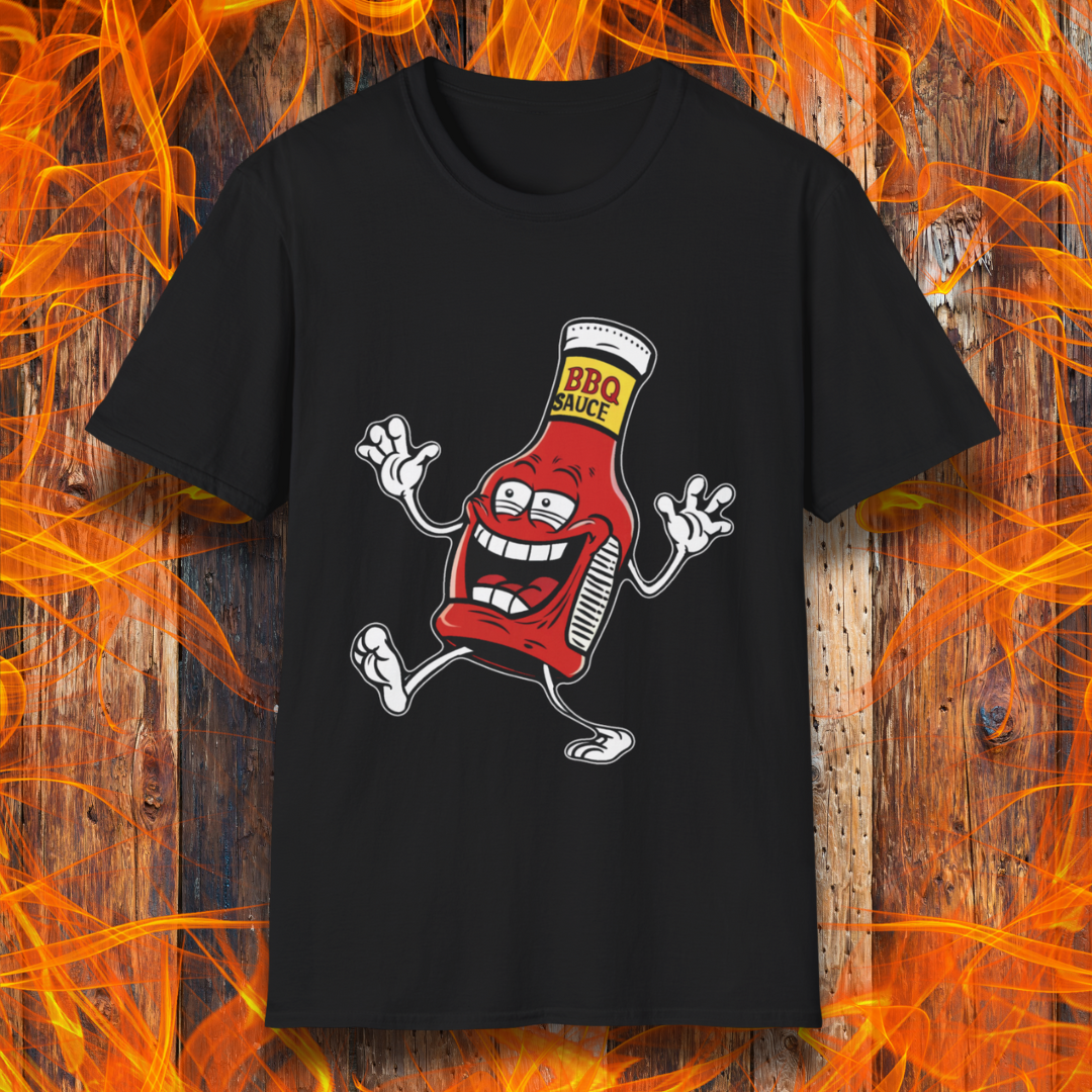 Black T-shirt with a cartoon BBQ sauce bottle, grinning and dancing with "BBQ SAUCE" on its label. Fun, fiery design for BBQ lovers.