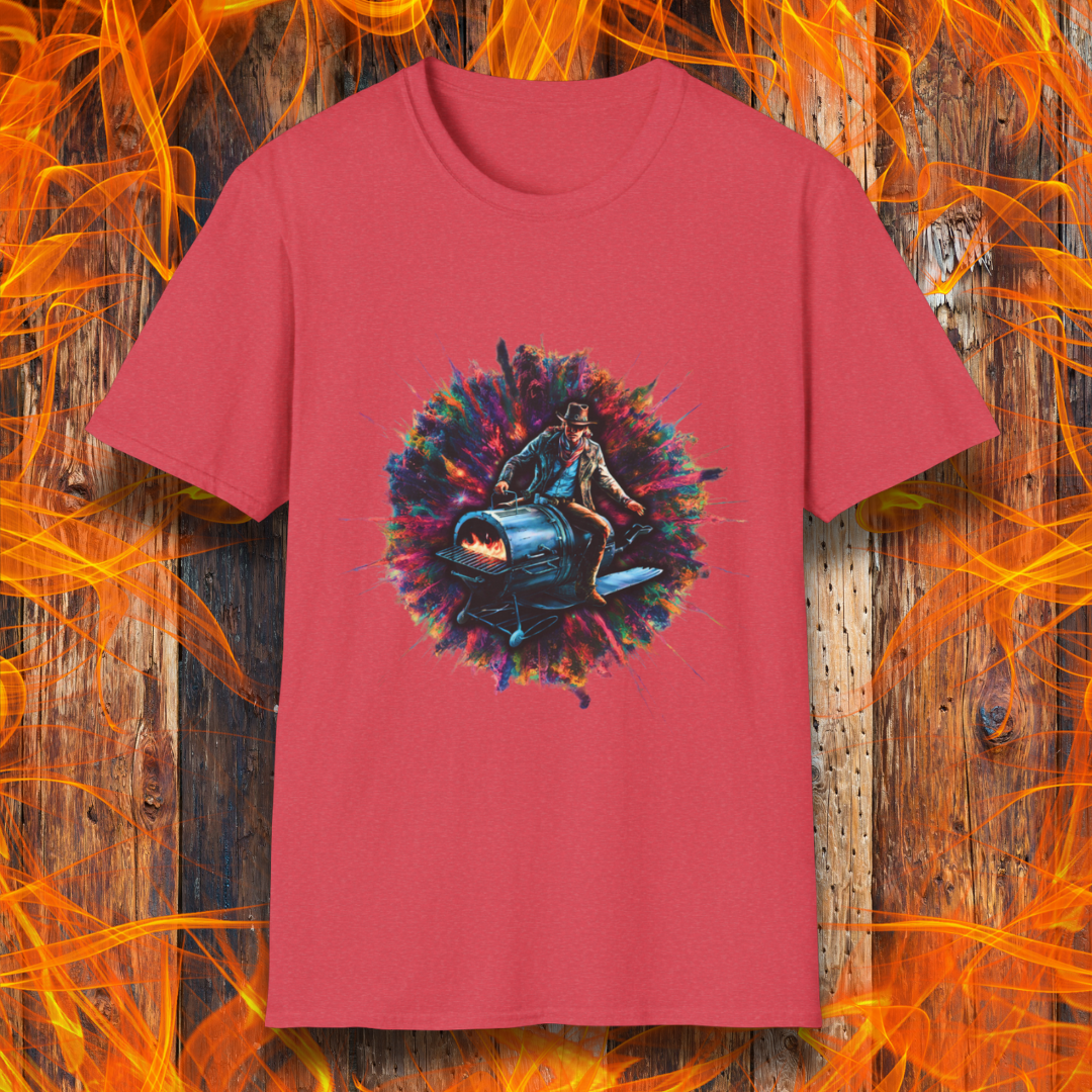 Heather Red T-shirt featuring a striking design of a cowboy riding a futuristic, rocket-powered barbecue smoker. The artwork is set against an explosive, colorful cosmic backdrop, blending elements of Western and sci-fi themes for a bold grilling statement.