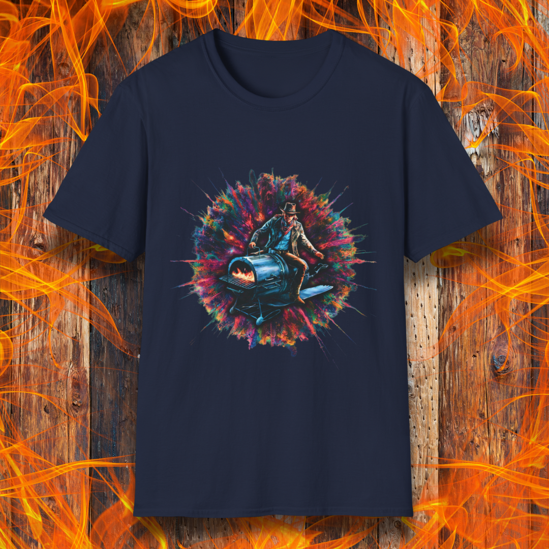 Navy T-shirt featuring a striking design of a cowboy riding a futuristic, rocket-powered barbecue smoker. The artwork is set against an explosive, colorful cosmic backdrop, blending elements of Western and sci-fi themes for a bold grilling statement.